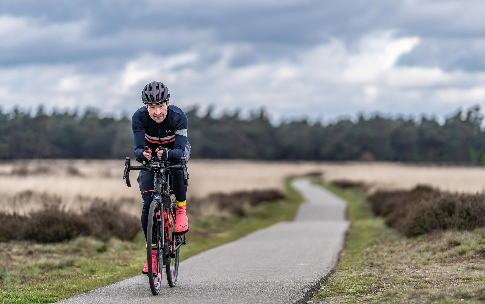 Cyclist riding a road bike on a path near Dundee, serviced by David Stephen Cycles